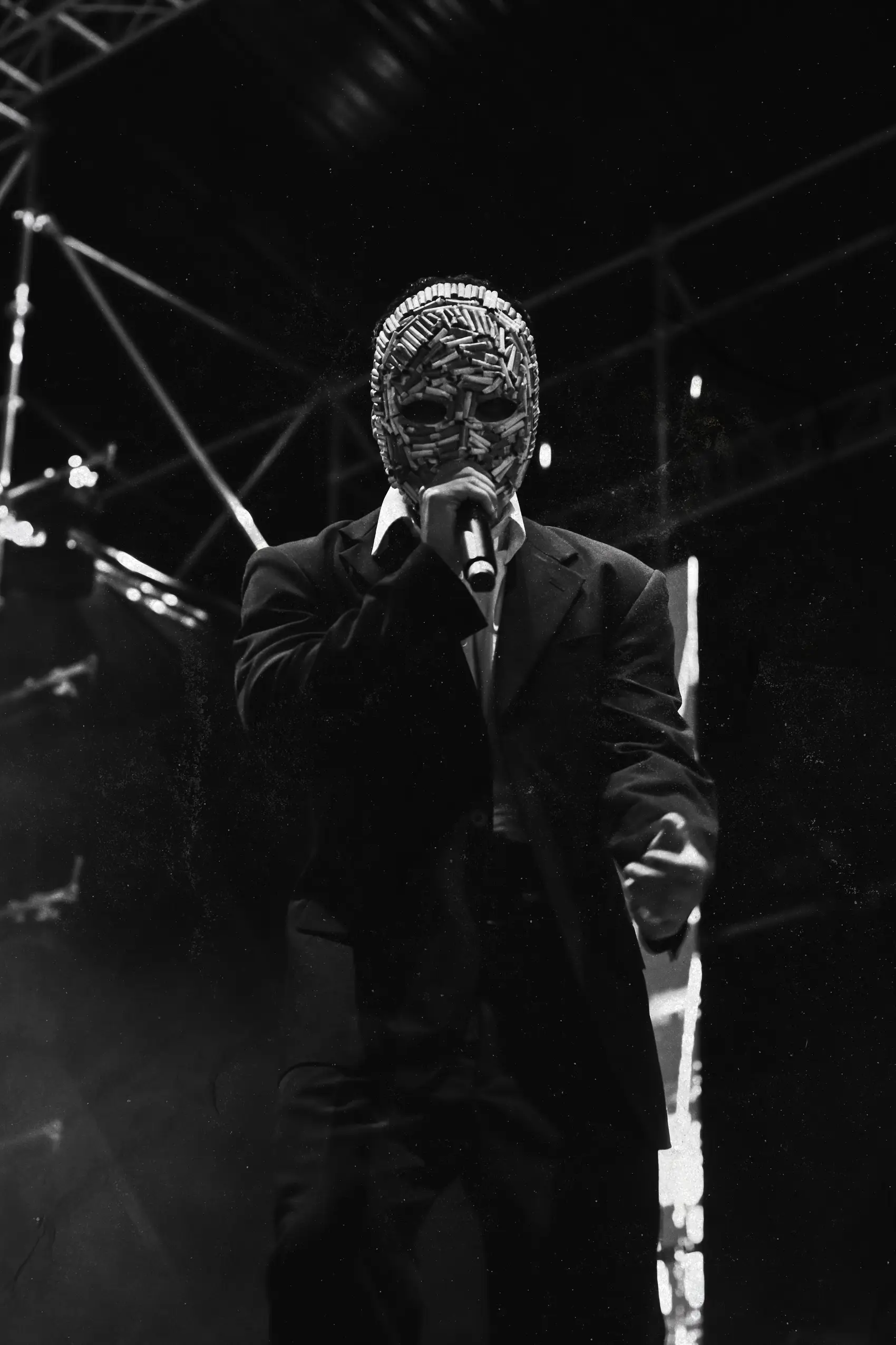Black and white portrait of an artist mid-performance in stage haze