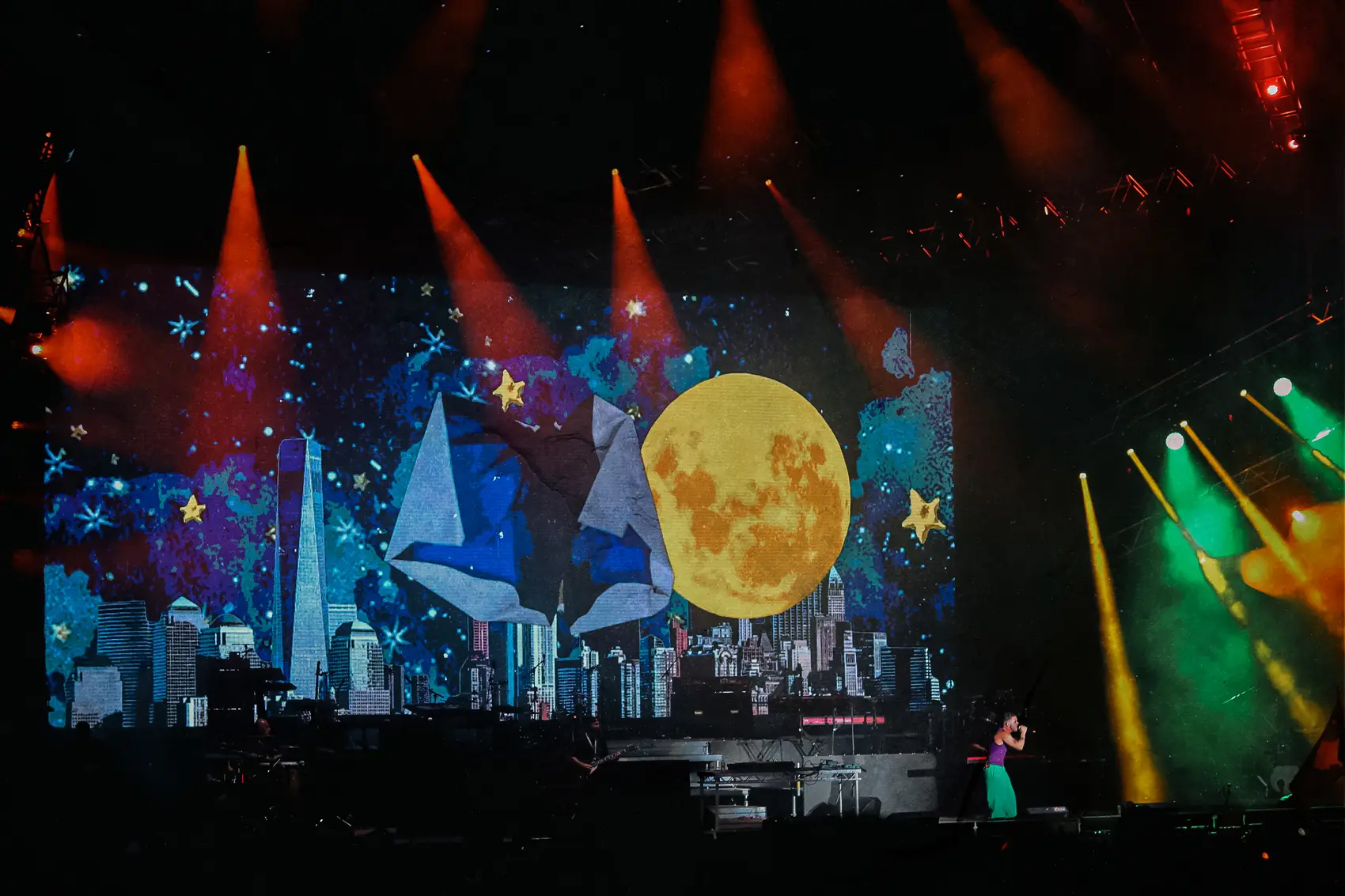 Giant moon stage design glowing above a festival audience