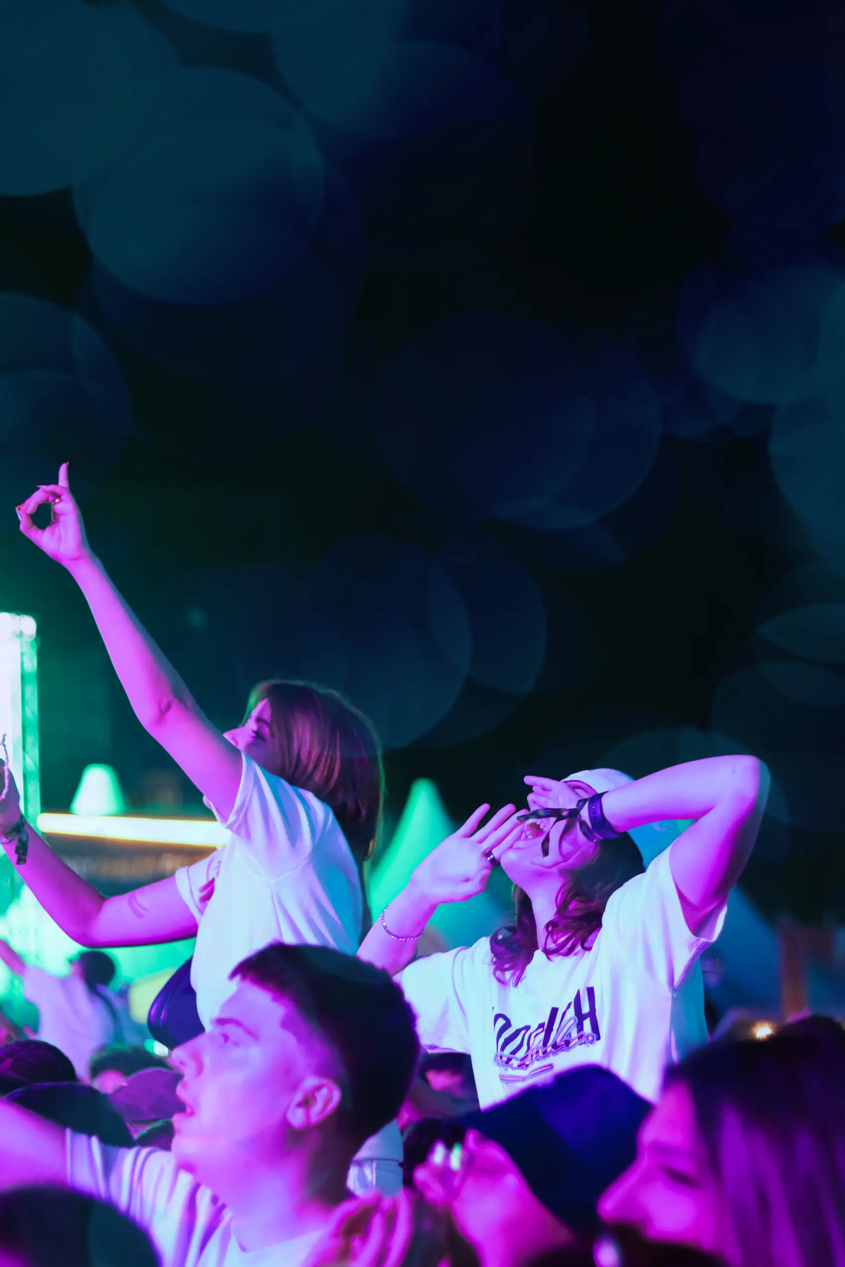 Crowd jumping in unison under blue light