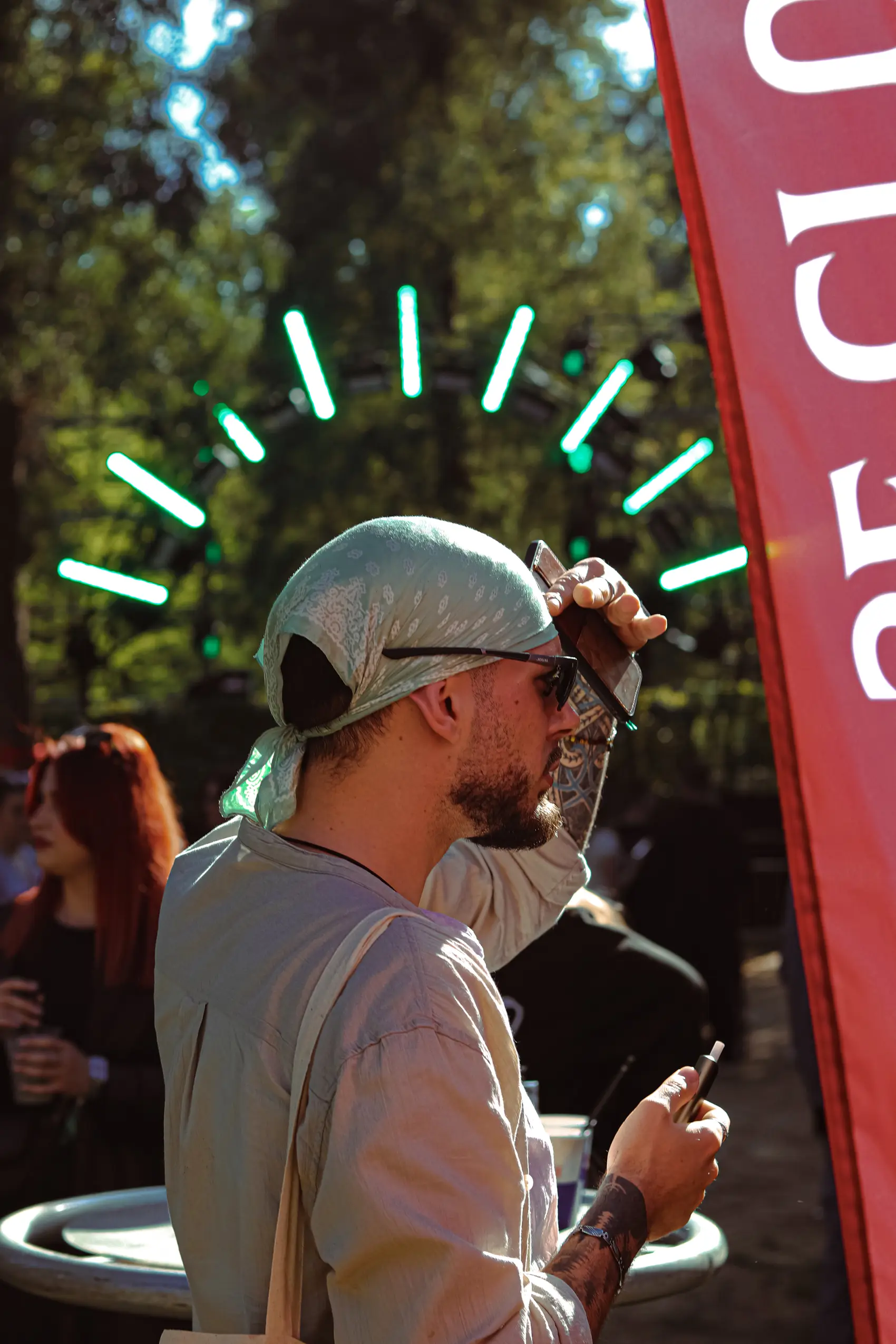 A reveller in a white cap framed by rays of light